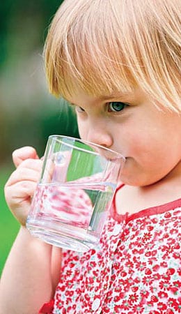 Young girl drinking water