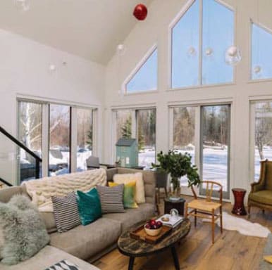 A pristine living room with lots of windows. 