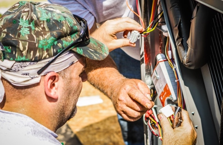 Service Technician repairing a HVAC unit.