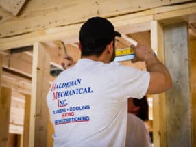 A man framing an interior wall.