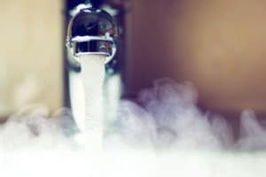 Hot water coming out of a sink. 