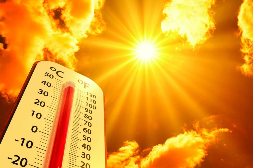 Thermometer on yellow sky with sun shining