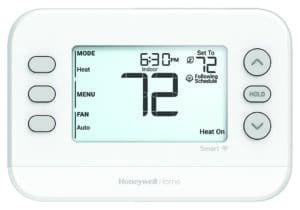 Close-up of a Honeywell Home smart thermostat set to 72 degrees, displaying current indoor temperature and heating mode.